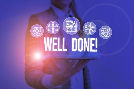 Writing note showing Well Done. Business concept for used praising demonstrating or group for something have done good way Woman wear formal work suit presenting presentation using smart deviceの写真素材