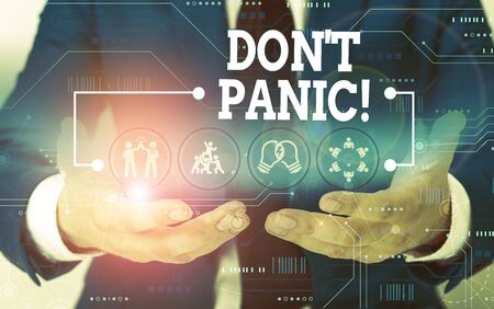 Conceptual hand writing showing Don T Panic. Concept meaning suddenly feel so worried or frightened that you can not behave Male wear formal suit presenting presentation smart deviceの写真素材