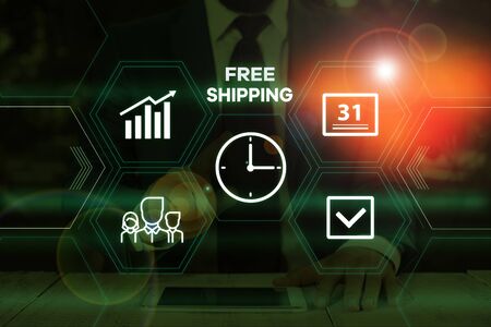 Handwriting text writing Free Shipping. Conceptual photo Freight Cargo Consignment Lading Payload Dispatch Cartage Male human wear formal work suit presenting presentation using smart deviceの写真素材