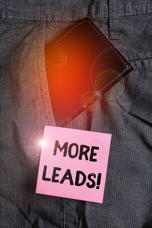 Conceptual hand writing showing More Leads. Concept meaning initiation of consumer interest or enquiry into product Small wallet inside trouser front pocket near notation paperの写真素材