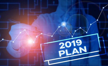 Handwriting text 2019 Plan. Conceptual photo setting up your goals and plans for the current year or in 2019 Woman wear formal work suit present presentation using smart latest deviceの写真素材