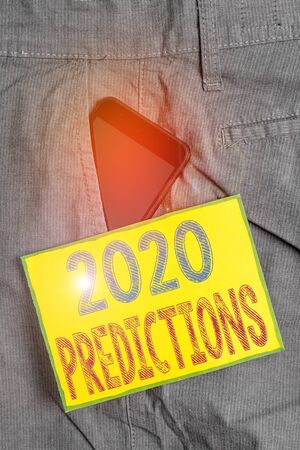 Conceptual hand writing showing 2020 Predictions. Concept meaning statement about what you think will happen in 2020 Smartphone device inside trousers front pocket note paperの写真素材