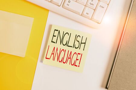 Text sign showing English Language. Business photo showcasing third spoken native lang in world after Chinese and Spanish Empty blank paper with copy space and pc keyboard above orange background tableの写真素材