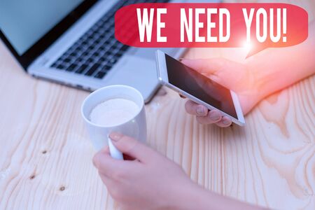 Text sign showing We Need You. Business photo text asking someone to work together for certain job or target woman laptop computer smartphone mug office supplies technological devicesの写真素材