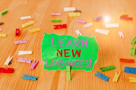 Word writing text Learn New Languages. Business photo showcasing developing ability to communicate in foreign lang Colored clothespin papers empty reminder wooden floor background officeの写真素材