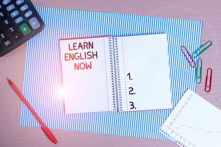 Text sign showing Learn English Now. Business photo text gain or acquire knowledge and skill of english language Striped paperboard notebook cardboard office study supplies chart paperの写真素材