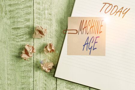 Writing note showing Machine Age. Business concept for period of development of new technology and industrial processes Notebook stationary placed above classic wooden backdropの写真素材