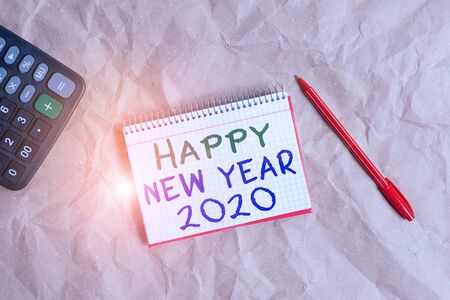 Word writing text Happy New Year 2020. Business photo showcasing Greeting Celebrating Holiday Fresh Start Best wishes Papercraft craft paper desk square spiral notebook office study suppliesの写真素材