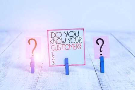 Conceptual hand writing showing Do You Know Your Customer Question. Concept meaning service identify clients with relevant information Crumbling sheet with paper clips placed on the wooden tableの写真素材