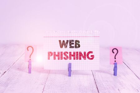 Text sign showing Web Phishing. Business photo showcasing fraudulent attempt to obtain sensitive details by disguising Scribbled and crumbling sheet with paper clips placed on the wooden tableの写真素材