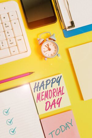 Writing note showing Happy Memorial Day. Business concept for Honoring Remembering those who died in military service White paper with copy space with paper clips clock and pc keyboardの写真素材