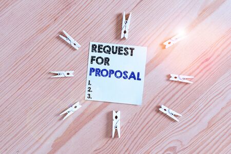 Word writing text Request For Proposal. Business photo showcasing document contains bidding process by agency or company Colored clothespin papers empty reminder wooden floor background officeの写真素材