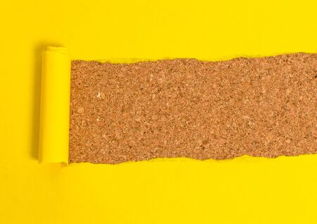 Cardboard which is torn in the middle placed above a wooden classic tableの写真素材