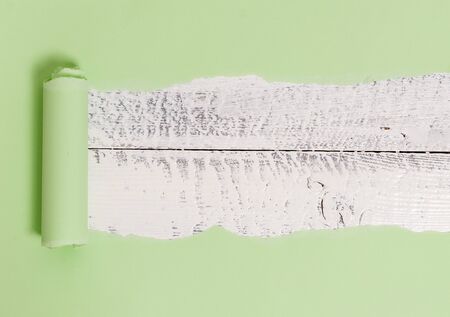 Cardboard which is torn in the middle placed above a wooden classic tableの写真素材