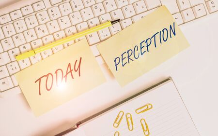 Conceptual hand writing showing Perception. Concept meaning individuals organize and interpret their sensory impressions Empty orange square papers by the pc keyboard with copy spaceの写真素材