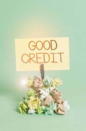 Word writing text Good Credit. Business photo showcasing borrower has a relatively high credit score and safe credit risk Reminder pile colored crumpled paper clothespin reminder blue backgroundの写真素材