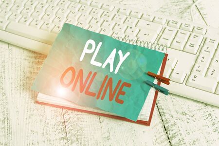 Word writing text Play Online. Business photo showcasing a video game played over some form of computer network notebook paper reminder clothespin pinned sheet white keyboard light woodenの写真素材