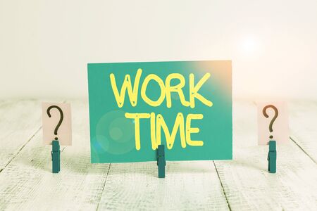 Word writing text Work Time. Business photo showcasing period starts when temporary workers are engaged at a worksite Scribbled and crumbling sheet with paper clips placed on the wooden tableの写真素材