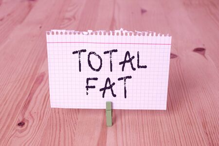 Word writing text Total Fat. Business photo showcasing combined value of the different types of fat shown at the label Empty reminder wooden floor background green clothespin groove slot officeの写真素材