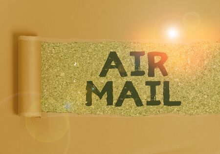 Text sign showing Air Mail. Business photo text the bags of letters and packages that are transported by aircraft Cardboard which is torn in the middle placed above a wooden classic tableの写真素材