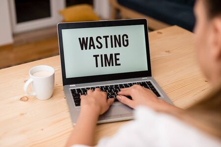 Writing note showing Wasting Time. Business concept for act of spending time doing something that is...