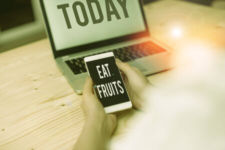 Text sign showing Eat Fruits. Business photo showcasing consume any product of plant growth useful to huanalysiss or animals woman laptop computer smartphone mug office supplies technological devicesの写真素材