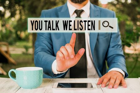 Handwriting text writing You Talk We Listen. Conceptual photo Two Way Communication Motivational Conversation Businessman with pointing finger in front of himの写真素材