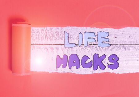 Word writing text Life Hacks. Business photo showcasing Strategy technique to analysisage daily activities more efficiently Cardboard which is torn in the middle placed above a wooden classic tableの写真素材