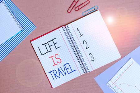 Conceptual hand writing showing Life Is Travel. Concept meaning Exposure to the diversity Tourism Promoting Landmarks Striped paperboard cardboard office study supplies chartの写真素材