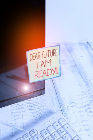 Handwriting text Dear Future I Am Ready. Conceptual photo state action situation being fully prepared Notation paper taped to black computer monitor screen near white keyboardの写真素材