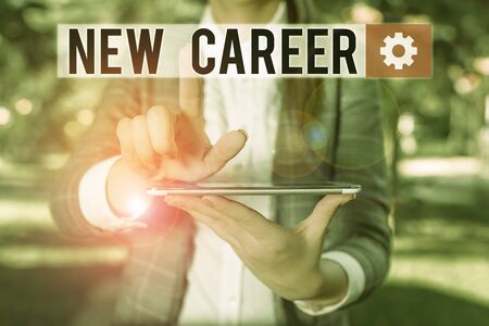 Text sign showing New Career. Business photo text a change to a different type of job from the one you have Outdoor scene with business woman holds lap top with touch screenの写真素材