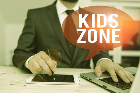 Word writing text Kids Zone. Business photo showcasing An area or a region designed to enable children to play and enjoy Male human wear formal clothes present presentation use hi tech smartphoneの写真素材