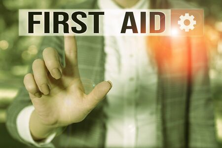 Text sign showing First Aid. Business photo showcasing Practise of healing small cuts that no need for medical training Business woman in the nature pointing with the finger into empty spaceの写真素材
