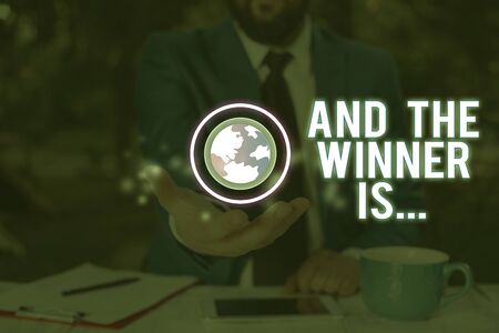 Conceptual hand writing showing And The Winner Is. Concept meaning Announcing who the Victor is Exemplar Achieverの写真素材