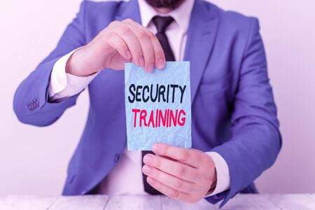 Conceptual hand writing showing Security Training. Concept meaning providing security awareness training for end users Man holds empty paper with copy space in front of him Spaceの写真素材
