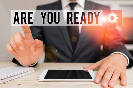 Word writing text Are You Ready. Business photo showcasing Alertness Preparedness Urgency Game Start Hurry Wide awake Male human wear formal clothes present presentation use hi tech smartphoneの写真素材