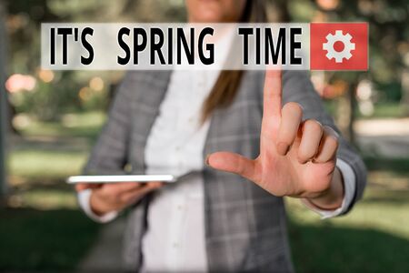 Writing note showing It S Spring Time. Business concept for Season After Winter Bloosoming of Flowers Transformation Outdoor scene with business woman holds lap top with touch screenの写真素材