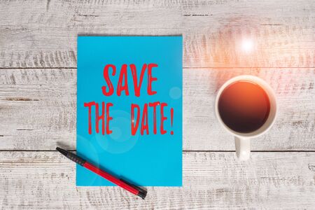Writing note showing Save The Date. Business concept for Organizing events well make day special event organizers Stationary placed next to a cup of black coffee above the wooden tableの写真素材