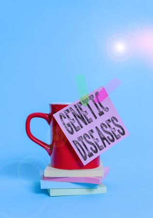 Writing note showing Genetic Diseases. Business concept for disease caused by an abnormality in an individual s is genome Cup colored sticky note banners stacked pads lying pastel backgroundの写真素材