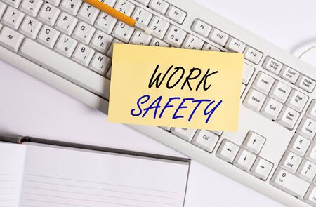 Word writing text Work Safety. Business photo showcasing policies and procedures in place to ensure safety in workplace White pc keyboard with empty note paper and paper clips above white backgroundの写真素材