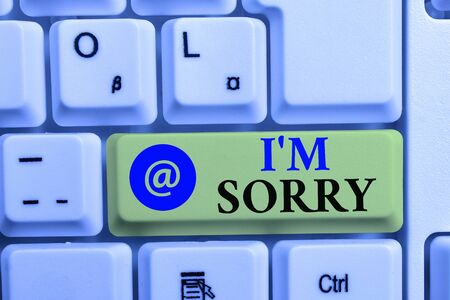 Writing note showing I M Sorry. Business concept for Toask for forgiveness to someone you unintensionaly hurt White pc keyboard with note paper above the white backgroundの写真素材