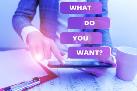 Text sign showing What Do You Want Question. Business photo text say or write in order to ask demonstrating about something Business concept with mobile phone in the handの写真素材