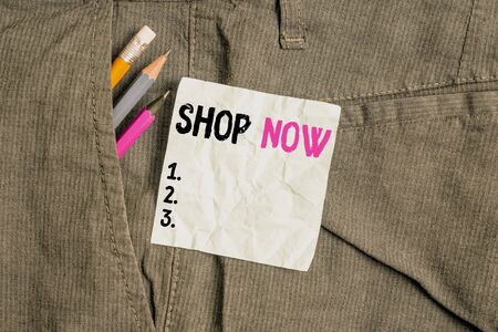 Word writing text Shop Now. Business photo showcasing the action or activity of purchasing goods from stores or online Writing equipment and blue note paper inside pocket of man work trousersの写真素材