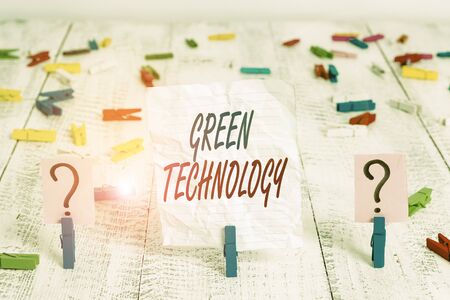 Handwriting text Green Technology. Conceptual photo reverse the effects of huanalysis activity on the environment Scribbled and crumbling sheet with paper clips placed on the wooden tableの写真素材