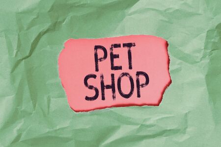 Handwriting text Pet Shop. Conceptual photo Retail business that sells different kinds of animals to the public Green crumpled ripped colored paper sheet centre torn colorful backgroundの写真素材