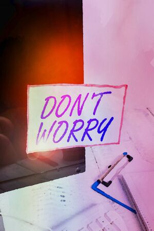 Text sign showing Don T Worry. Business photo text used to say for trying to make someone less nervous or upset Note paper taped to black computer screen near keyboard and stationaryの写真素材