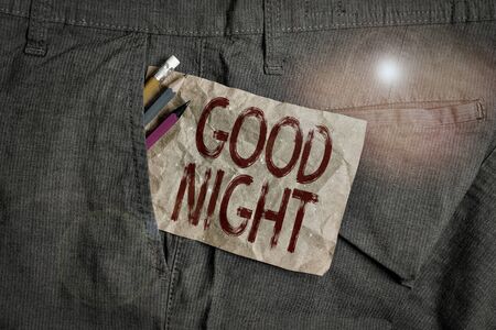 Word writing text Good Night. Business photo showcasing expressing good wishes on parting at night or before going to bed Writing equipment and brown note paper inside pocket of man work trousersの写真素材