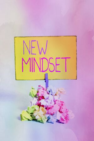 Text sign showing New Mindset. Business photo showcasing Mental attitude or disposition New approach in dealing situation Reminder pile colored crumpled paper clothespin reminder blue backgroundの写真素材