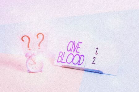 Writing note showing Give Blood. Business concept for demonstrating voluntarily has blood drawn and...