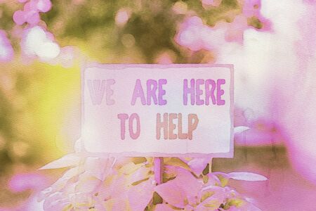 Text sign showing We Are Here To Help. Business photo text Someone who is always ready to Assist Support Give Plain empty paper attached to a stick and placed in the green leafy plantsの写真素材